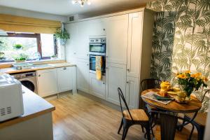 a kitchen with a table and a dining room at Kelswick Lodge in Nelson