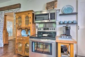 a kitchen with a stove and a microwave at Historic Biloxi Bay Cottage with Beautiful View in Ocean Springs +26 photos