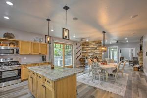 a kitchen with a table and a dining room at Bright Lower-Level Unit about 1 Mile to Lake Mich in Ludington