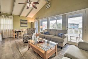 a living room with a couch and a table at 2nd-Row Holden Beach Abode - Steps to Ocean! in Holden Beach