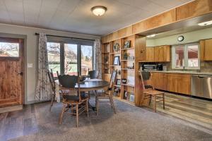 a kitchen and dining room with a table and chairs at Cozy Choteau Home with Fire Pit, Grill, Yard! in Choteau