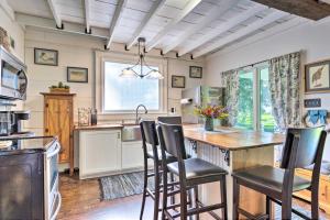 a kitchen with a table and chairs in a kitchen at Historic Biloxi Bay Cottage with Beautiful View in Ocean Springs