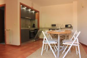 a kitchen with a table and chairs in a room at Meiros House Tourism and Nature in Amares