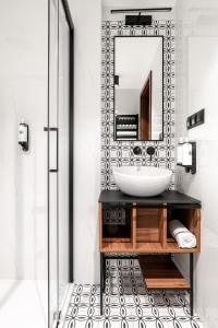 a bathroom with a sink and a mirror at Hotel Vestina in Wisła