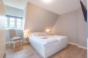 En eller flere senge i et værelse på Haus Inselurlaub Hausteil 2