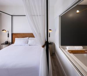 a bedroom with a white bed and a window at Estérel Resort in Esterel