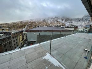a view from the roof of a building with a snow covered mountain at Immodelpas sky in Pas de la Casa