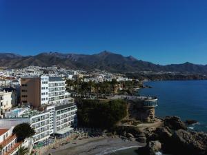 a view of a city with the ocean and mountains at Hotel Balcón de Europa in Nerja