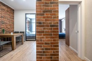 a brick wall in a room with a dining room at Атмосферні 4 квартирина поряд, 5 станція фонтану, з власним балконом fainorent in Odesa +53 photos