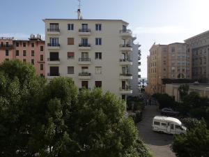 a white van parked in a parking lot next to a building at Rue de France mer à 200m in Nice
