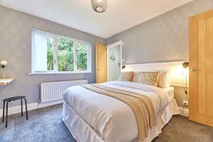 a bedroom with a large bed and a window at Host & Stay - Highfield in Newton on the Moor