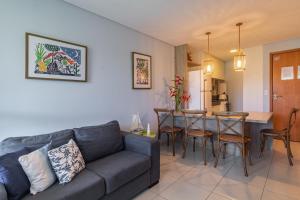 a living room with a couch and a table at Carneiro Beach Resort 305 in Tamandaré