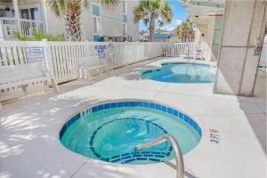 two swimming pools in a courtyard with a bench at Stunning 8 BR, New Updates, Walk to Beach Bars, Main Street in Myrtle Beach