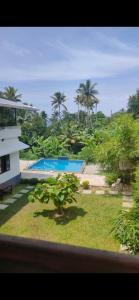 a view from a window of a resort with a swimming pool at Tamarind Villa in Varkala
