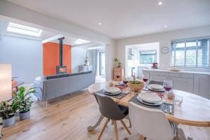 a dining room and kitchen with a table and chairs at Festival House, Snape in Saxmundham