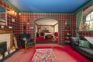 a living room with red tiled walls and a fireplace at Finest Retreats - The White House of Park in Cornhill