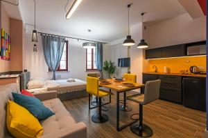 a living room with a couch and a table at Galeria Italiana Apartments in Wrocław