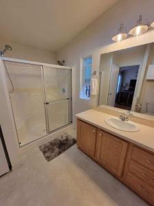 a bathroom with a shower and a sink and a mirror at Crater Lake Gateway-Rocky Point Resort in Klamath Falls