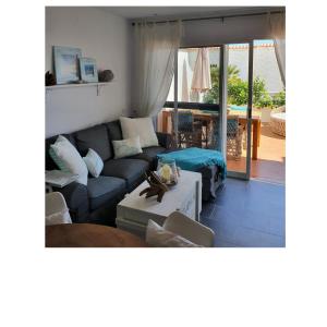 a living room with a couch and a table at Casa BLANKA Bahia Playa Anlage Costa Calma in Costa Calma