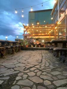a patio with lights and benches in front of a building at Cabinas Vista Al Golfo in Monteverde Costa Rica