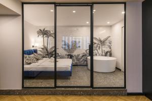 a room with a bed and a tub in a room at Galeria Italiana Apartments in Wrocław