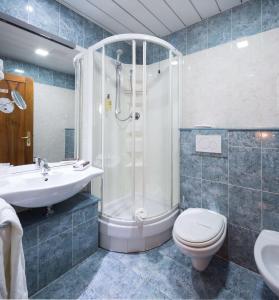 a bathroom with a shower and a toilet and a sink at La Villa - Sure Hotel Collection by Best Western in Ivrea