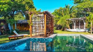 a resort with a swimming pool and a house at Pousada Quinta da Lagoa Azul in Jijoca de Jericoacoara