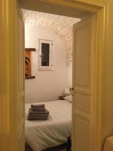 een slaapkamer met een bed in een kamer met een boog bij casa mia in Ostuni