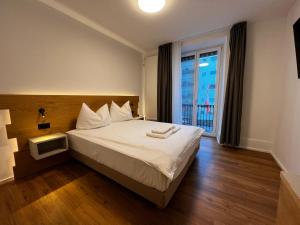Postel nebo postele na pokoji v ubytování smartroom Rössli Hunzenschwil