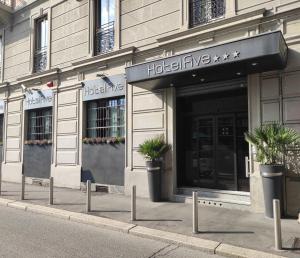 a building with potted plants in front of it at Hotel Five in Milan