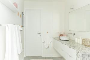 bagno bianco con lavandino e doccia di Trendy Apartments as Base to Discover Ghent a Gand