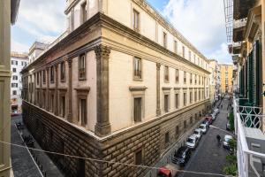 a large brick building with cars parked on a street at Interno Barocco in Naples