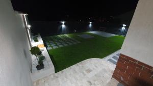 an aerial view of a backyard at night at Casa mica Resita in Reşiţa