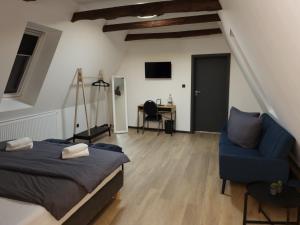 a bedroom with a bed and a chair and a desk at Hotel Zur Krone in Nordwalde