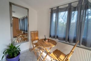 a table and chairs in a room with a window at Apartman Marija Imotski in Imotski