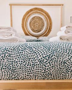 a bed with a blue and white comforter on it at Stellammare Apulian House B&B in Bari