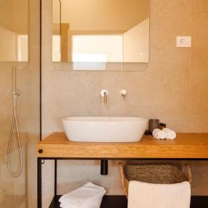 W łazience znajduje się biała umywalka i lustro. w obiekcie Tavarneta Estate w mieście Dobrovo