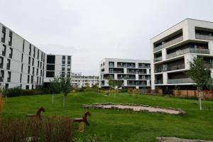 a building with statues of horses in a field at Branickiego 23 Apartment close to Medicover and Paley in Warsaw