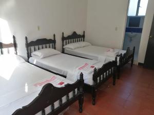 A bed or beds in a room at Hotel Olga Luz