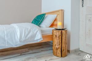 a bed with a candle on a wooden table at Agroturystyka Corno Owca in Żabnica