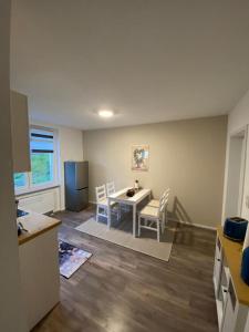 a kitchen and dining room with a table and chairs at ferienwohnungen.ruhla in Ruhla +39 photos