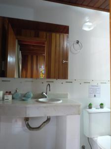 a bathroom with a sink and a toilet at Pousada Refugio do Pirata in Trindade