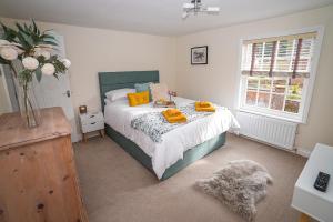 a bedroom with a bed with yellow pillows on it at Fourteen westgate in Louth