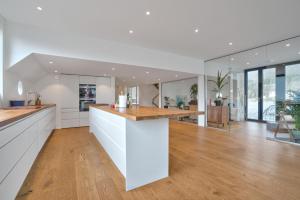 an open kitchen with white countertops and wooden floors at Volda Floating Home in Kvaløya