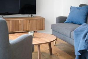 a living room with two couches and a tv at Volda Floating Home in Kvaløya