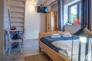 a bedroom with a wooden bed and a staircase at Agroturystyka Corno Owca in Żabnica