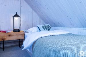a bedroom with a bed and a table with a lamp at Agroturystyka Corno Owca in Żabnica
