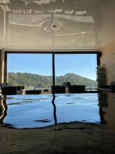 a large room with a large window and a table with chairs at Apartman M&S - Zoned 2 in Kopaonik