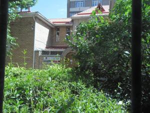 een huis gezien door een raam met bomen bij Best-BishkekCity Apartment 3 in Bisjkek
