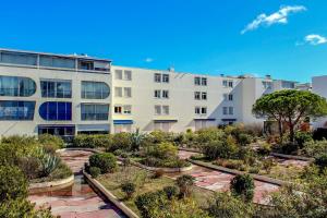 an apartment building with a garden in front of it at Miracle Morning in La Grande Motte +2 photos